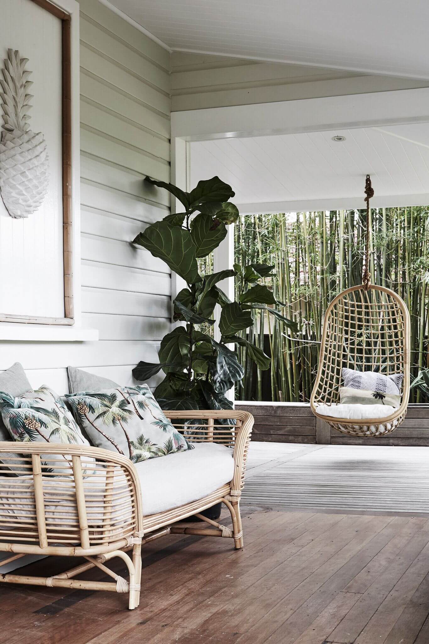 Undercover verandah at The Cottage, Byron Beach Abodes with cane lounge and hanging chair