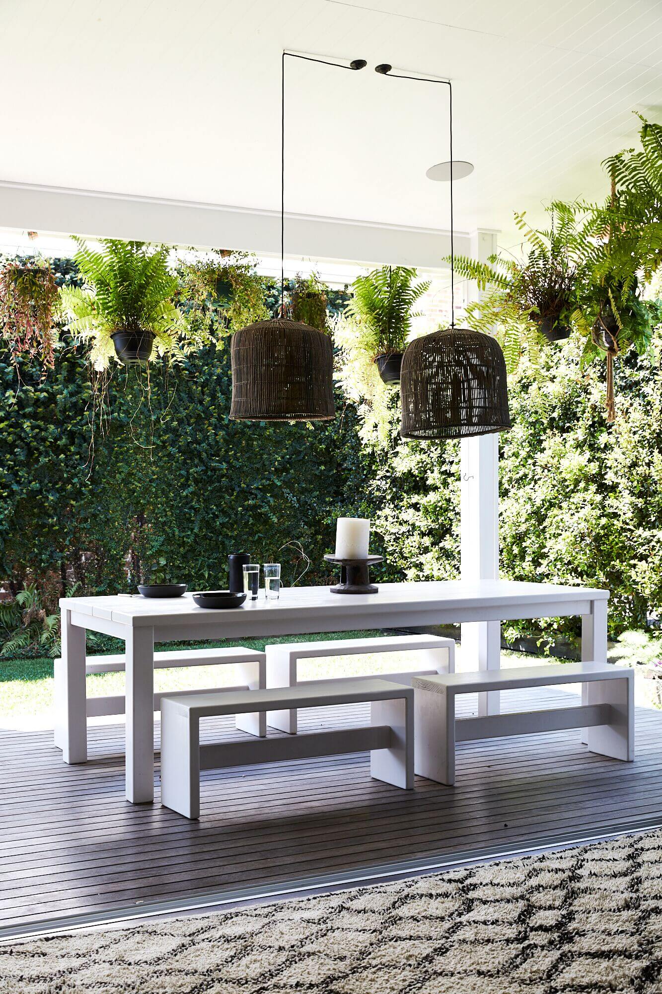 Outdoor dining area overlooking the lush green garden at Magnolia House, Byron Beach Abodes