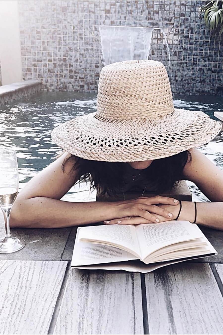Woman reading by the pool at The Villas of Byron