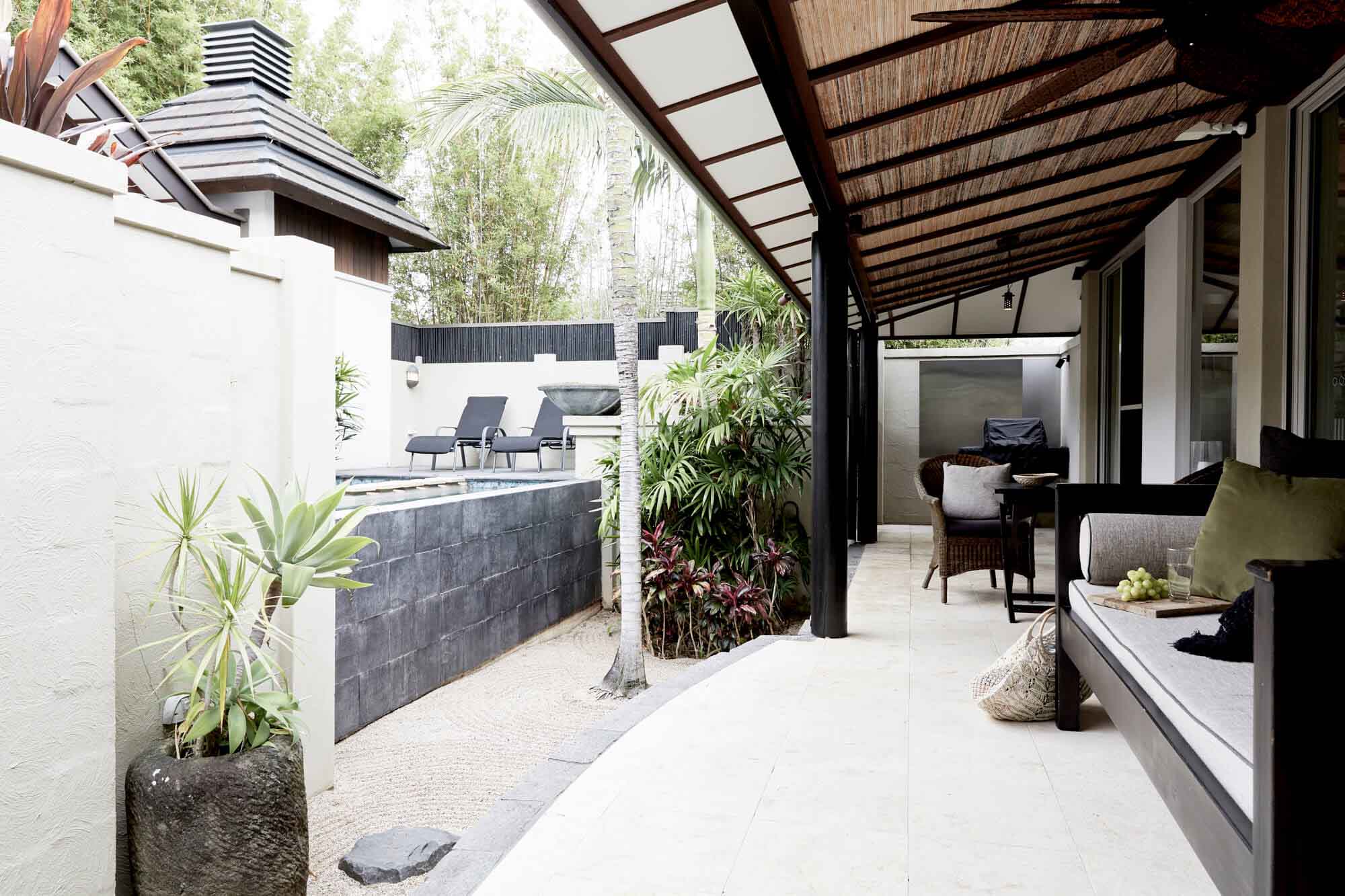 Lush outdoor area at The Villas of Byron with undercover seating, bbq, mineral pool, spa and raked zen garden