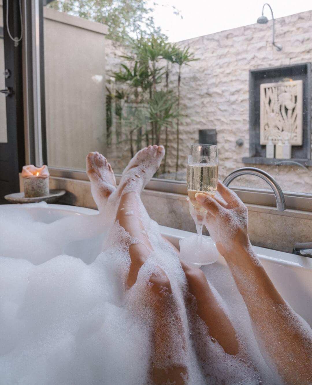 Relaxing in the bath with a glass of champagne at The Villas of Byron