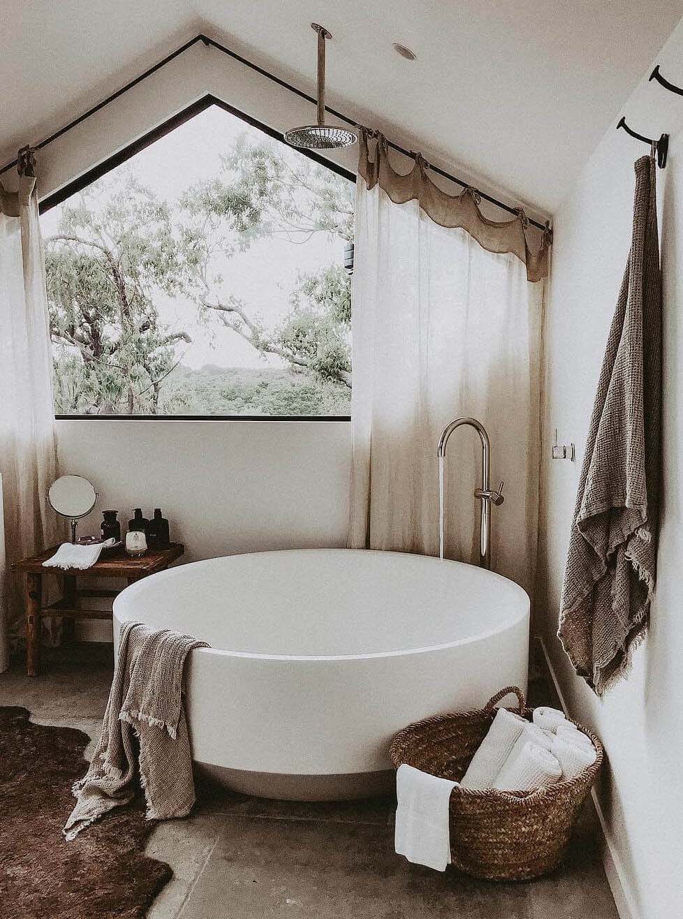 Ensuite at The Cabin, Byron Beach Abodes with round stone bath, custom angled window and floor to ceiling linen curtains