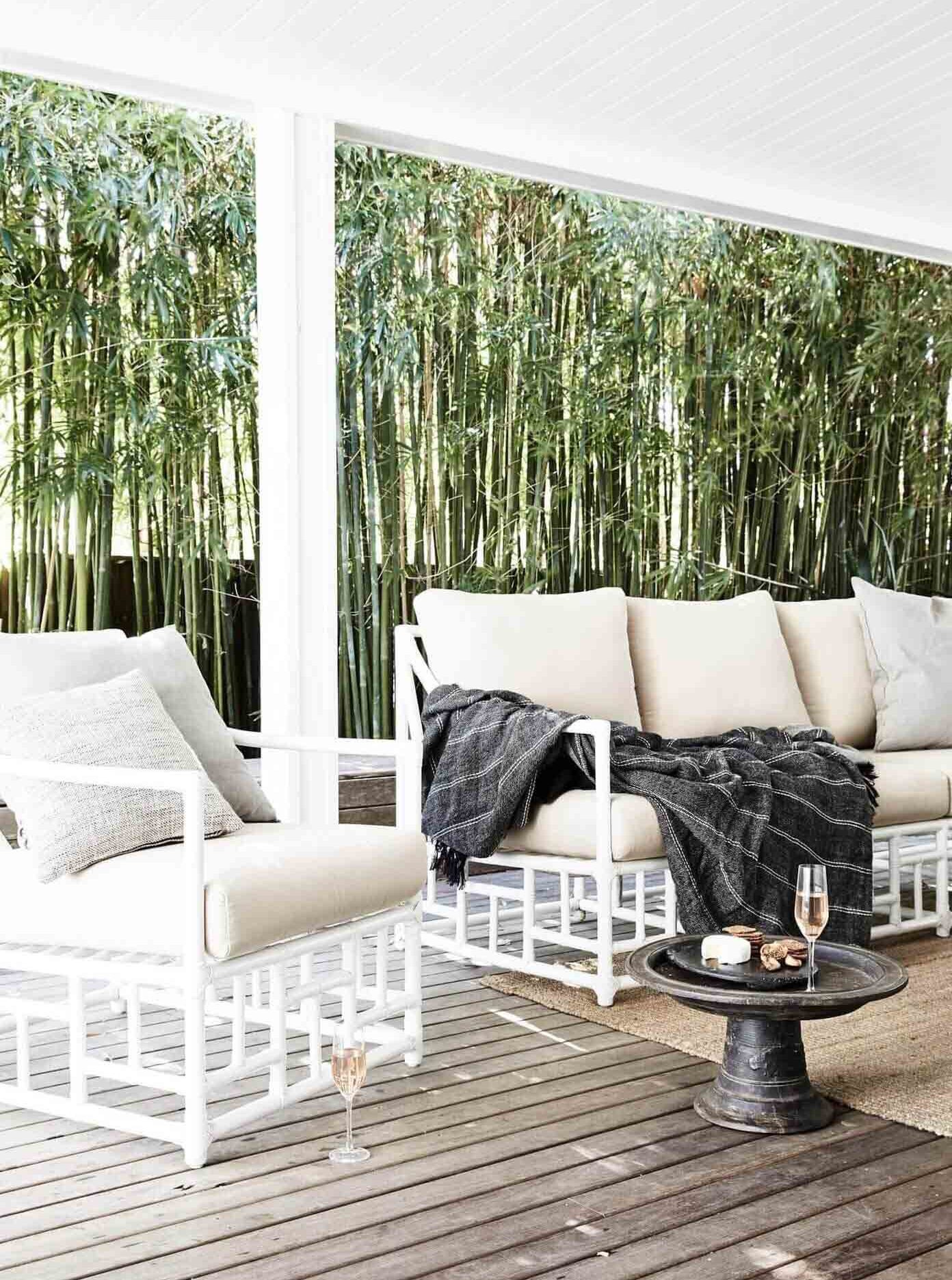 Covered outdoor entertaining area with cane lounge at The Cottage, Byron Beach Abodes