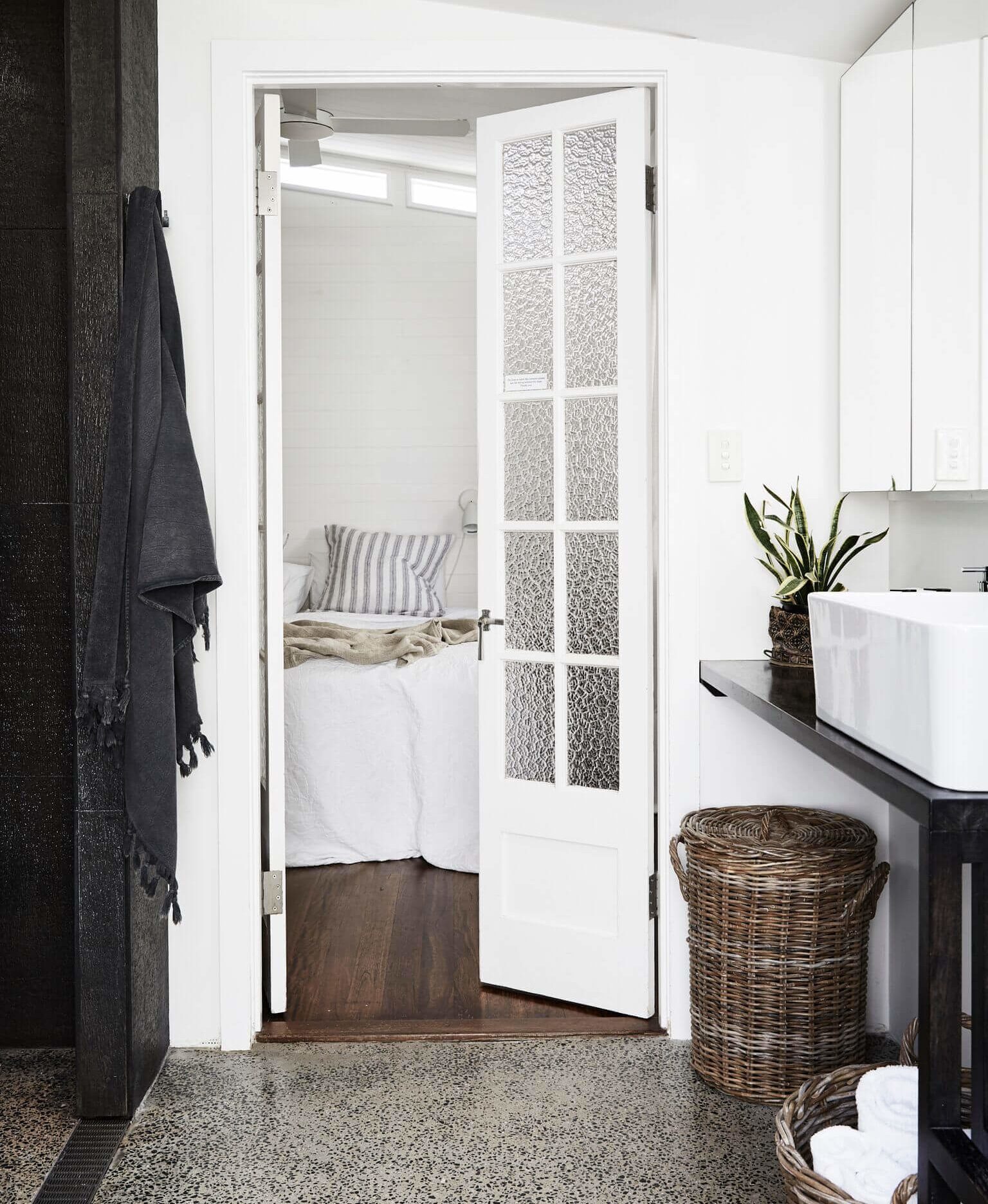 The main ensuite leading into the master bedroom through vintage panelled doors at The Cottage, Byron Beach Abodes