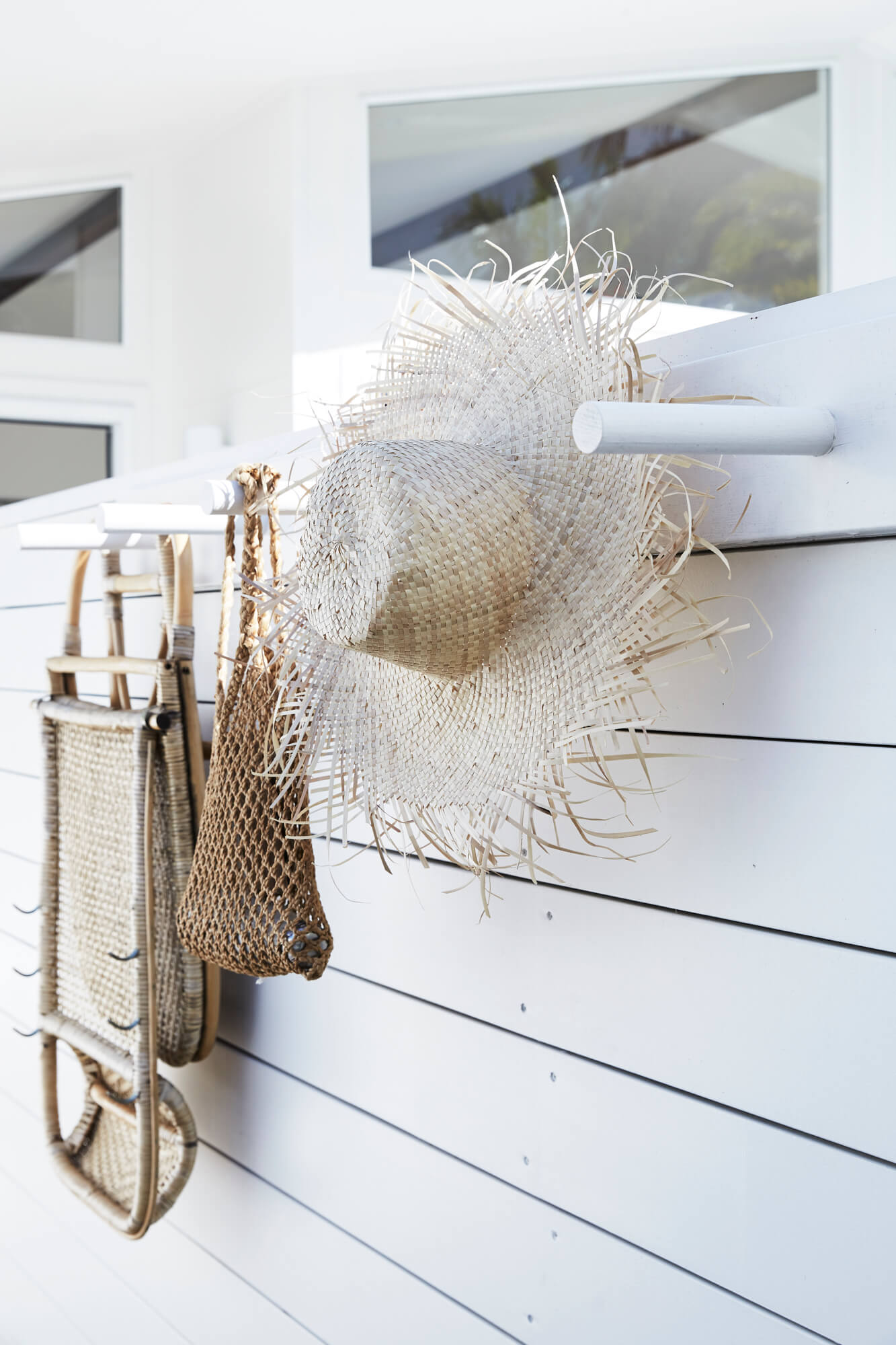 Outdoor wall hooks at The Chalet, Byron Beach Abodes with straw hat, beach bag and beach chair