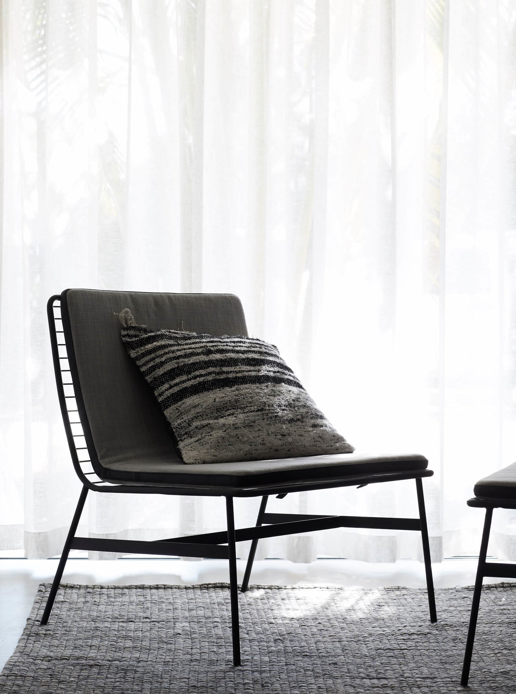 Charcoal occasional chair with cushion at the Bower Suites, The Bower Byron Bay hotel