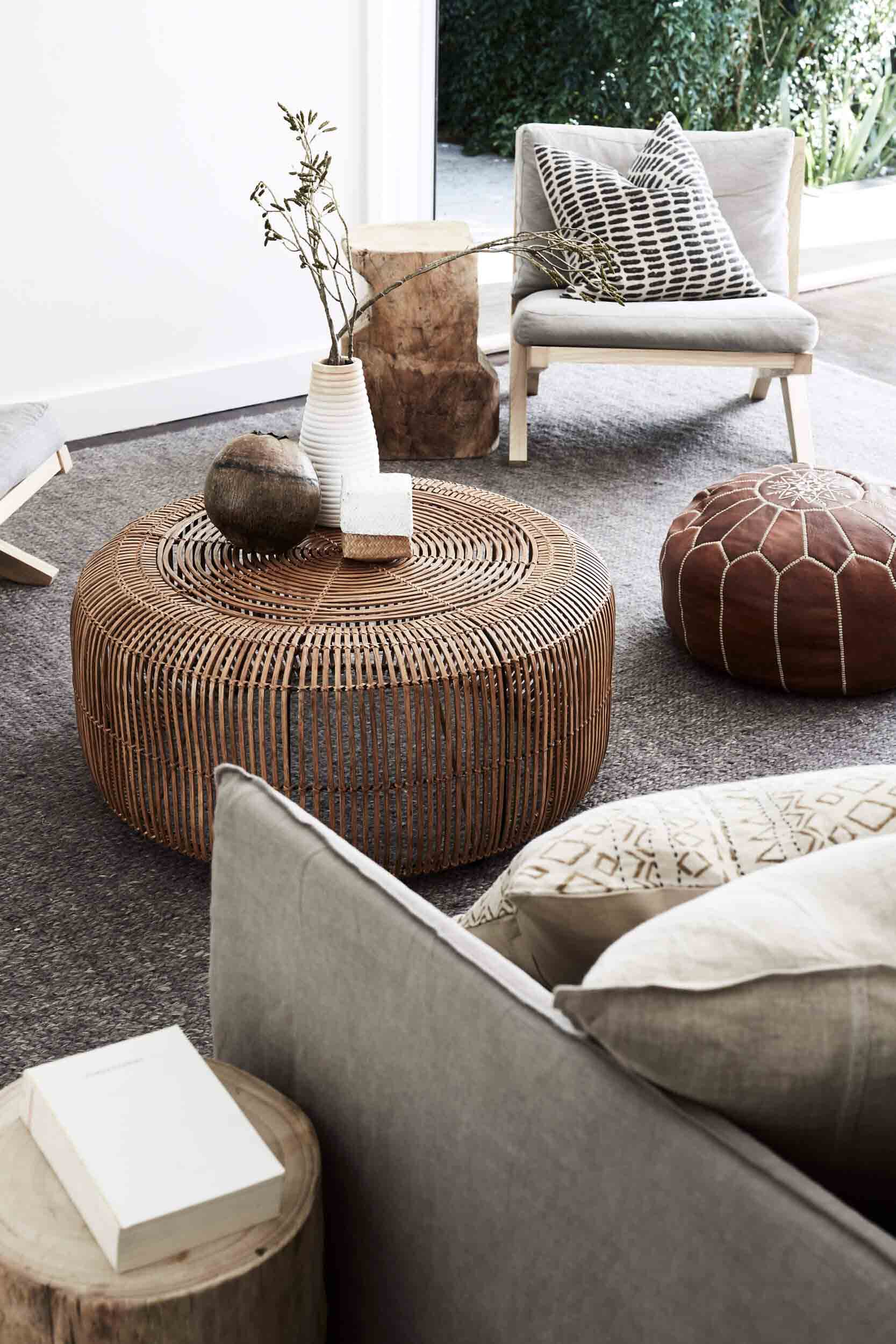 Lounge room at The Cottage, The Bower Byron Bay with cane coffee table, line lounge and leather pouffe