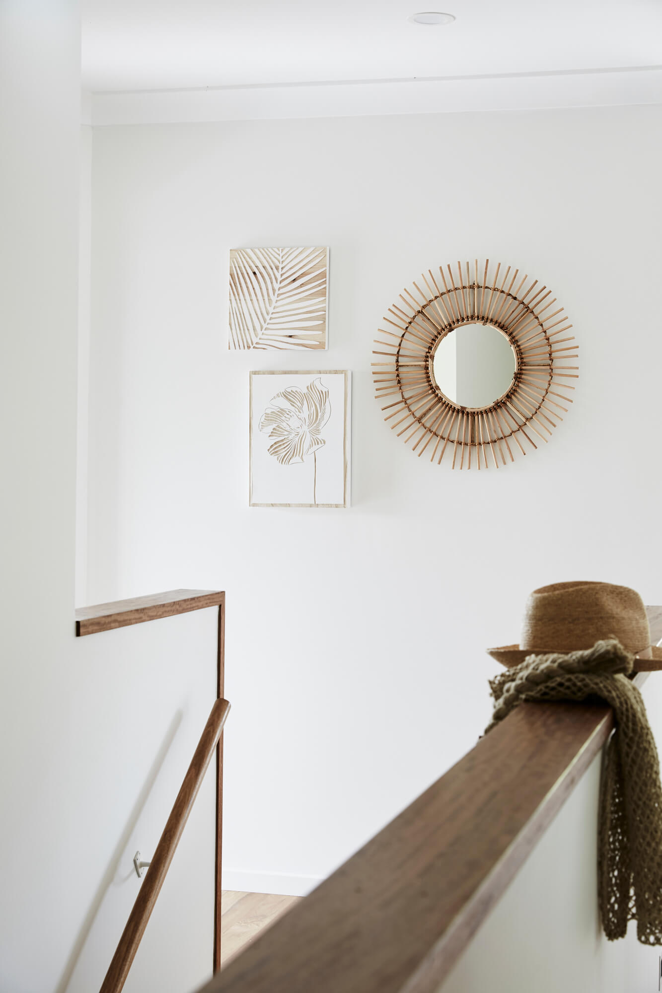 Curated wall art and rattan mirror at the Bower House, The Bower Byron Bay