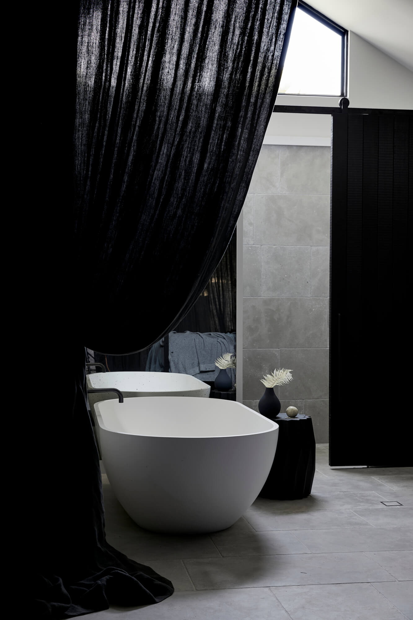 Curved white stone bath in the Bower Studios at The Bower Byron Bay hotel