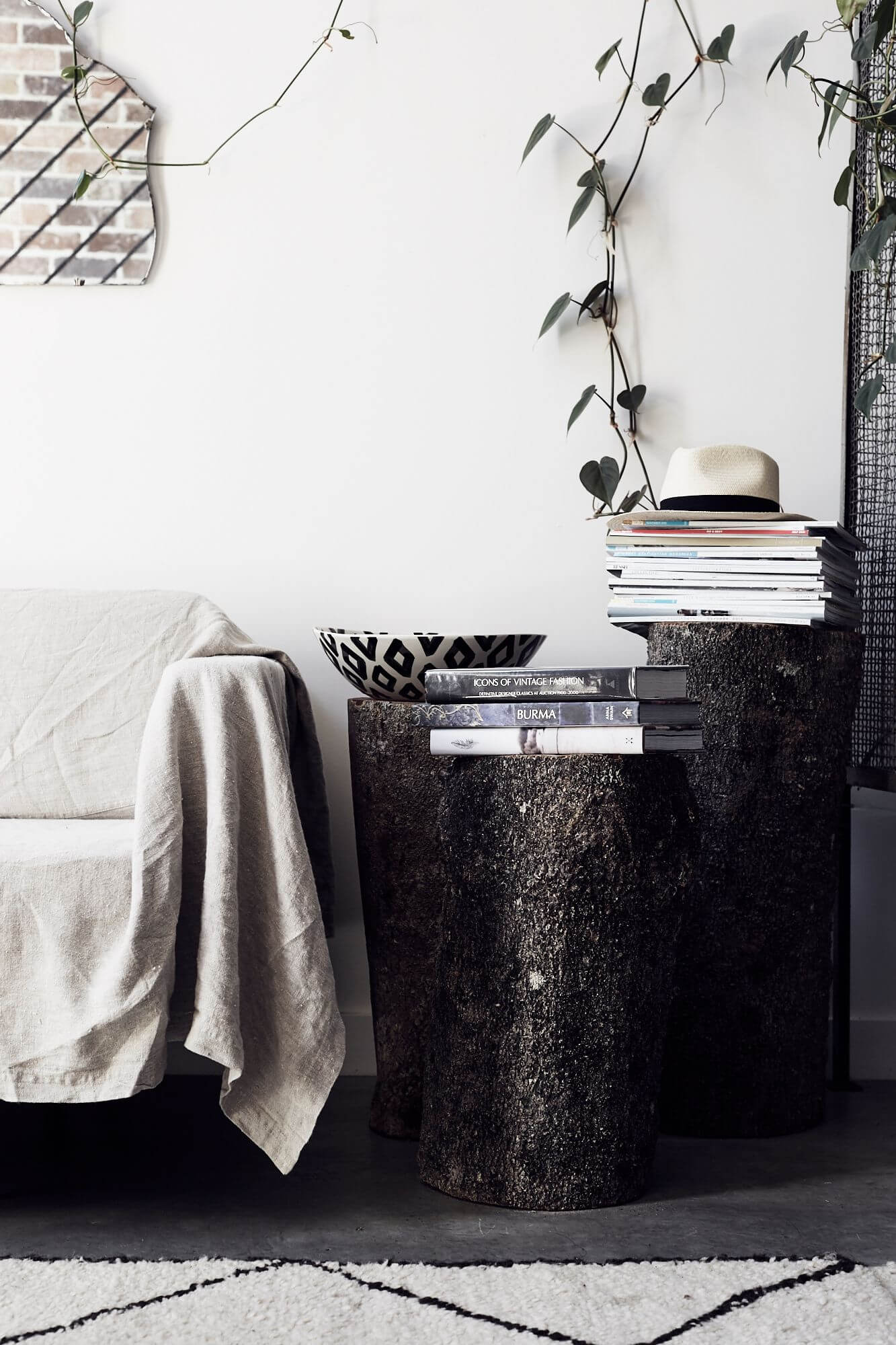 Log side tables with stacked books at The Chapel, Byron Beach Abodes
