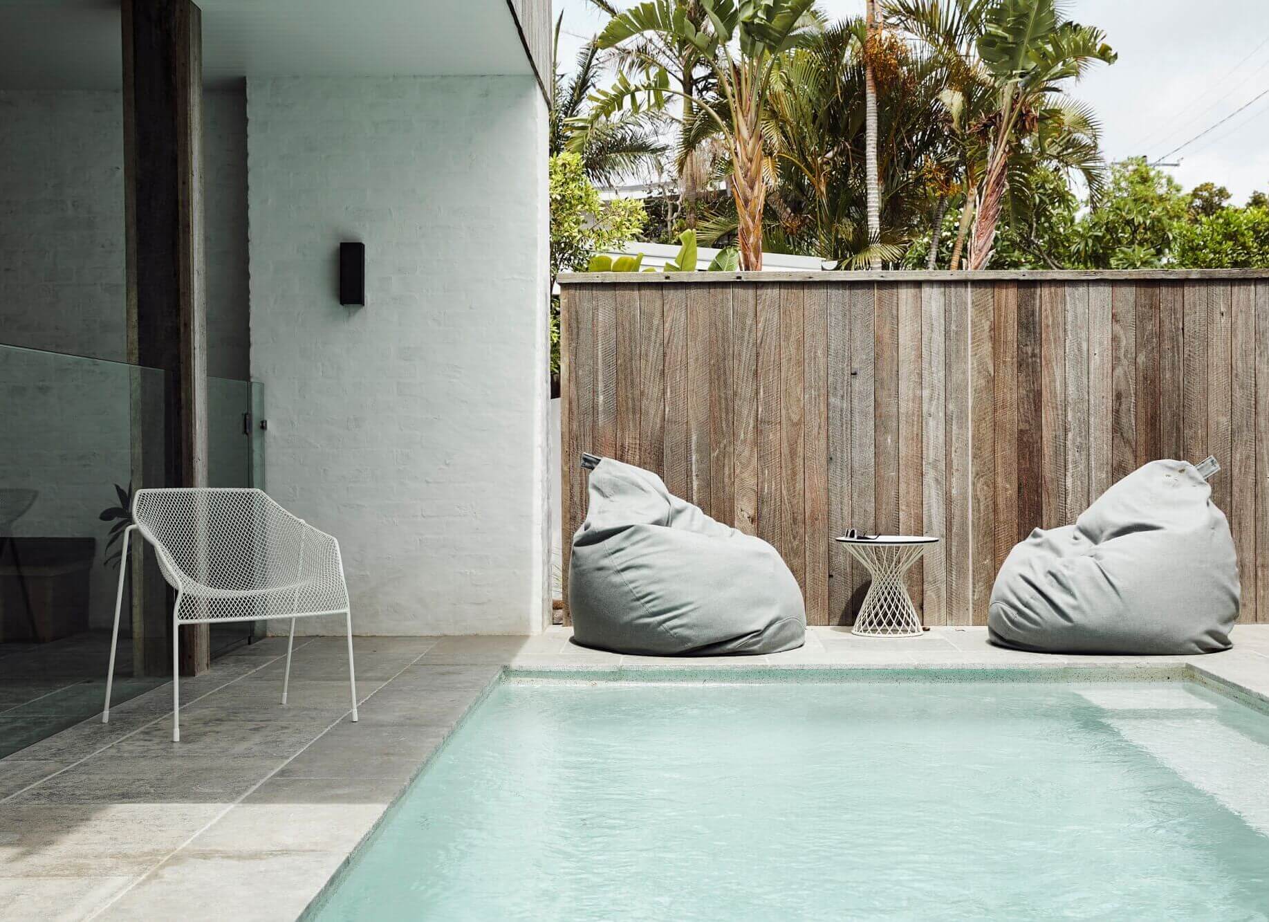 Cosy outdoor beanbags beside the pool at The Lodge, Byron Beach Abodes