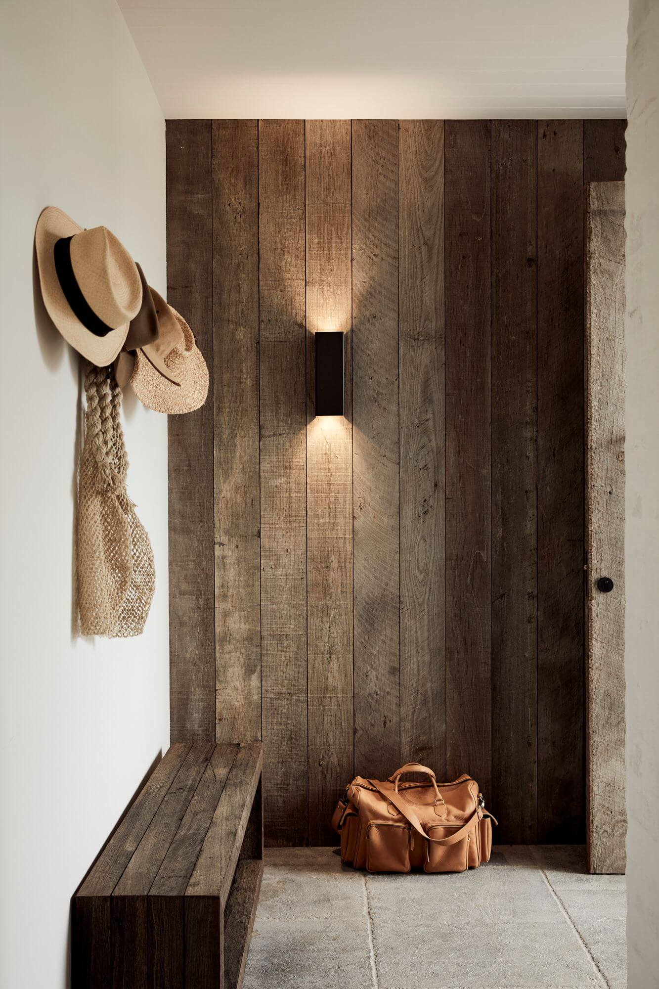 Entryway at The Lodge, Byron Beach Abodes with walls clad in recycled Jarrah timber cladding